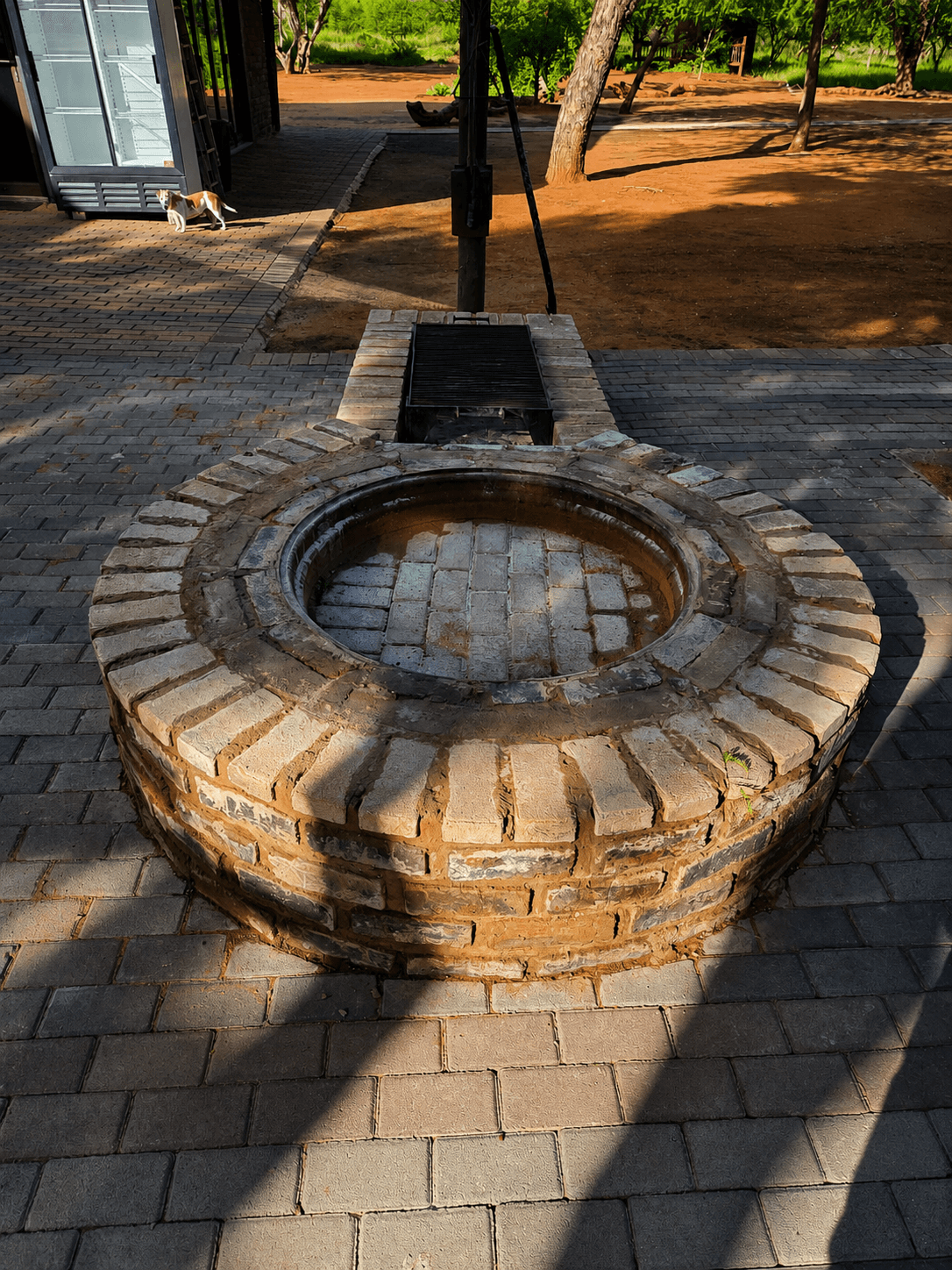 Traditional brick firepit on the lodge patio at Bougasvlei Safaris